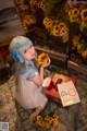 A woman with blue hair sitting on the floor holding a sunflower.