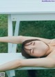 A woman laying on a white bench with her eyes closed.