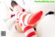 A woman in red and white striped stockings laying on a bed.