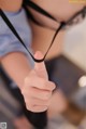 A close up of a person holding a black strap.