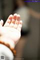 A close up of a person's hand with a rosary on it.