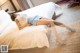 A woman laying on a bed in a hotel room.